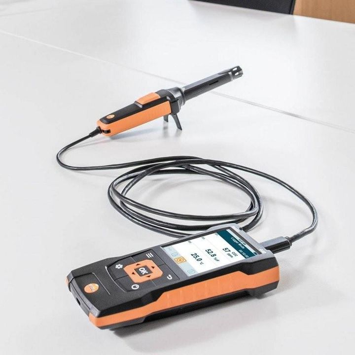 Appareil Testo 440 relié par un câble à une sonde, posé sur une table